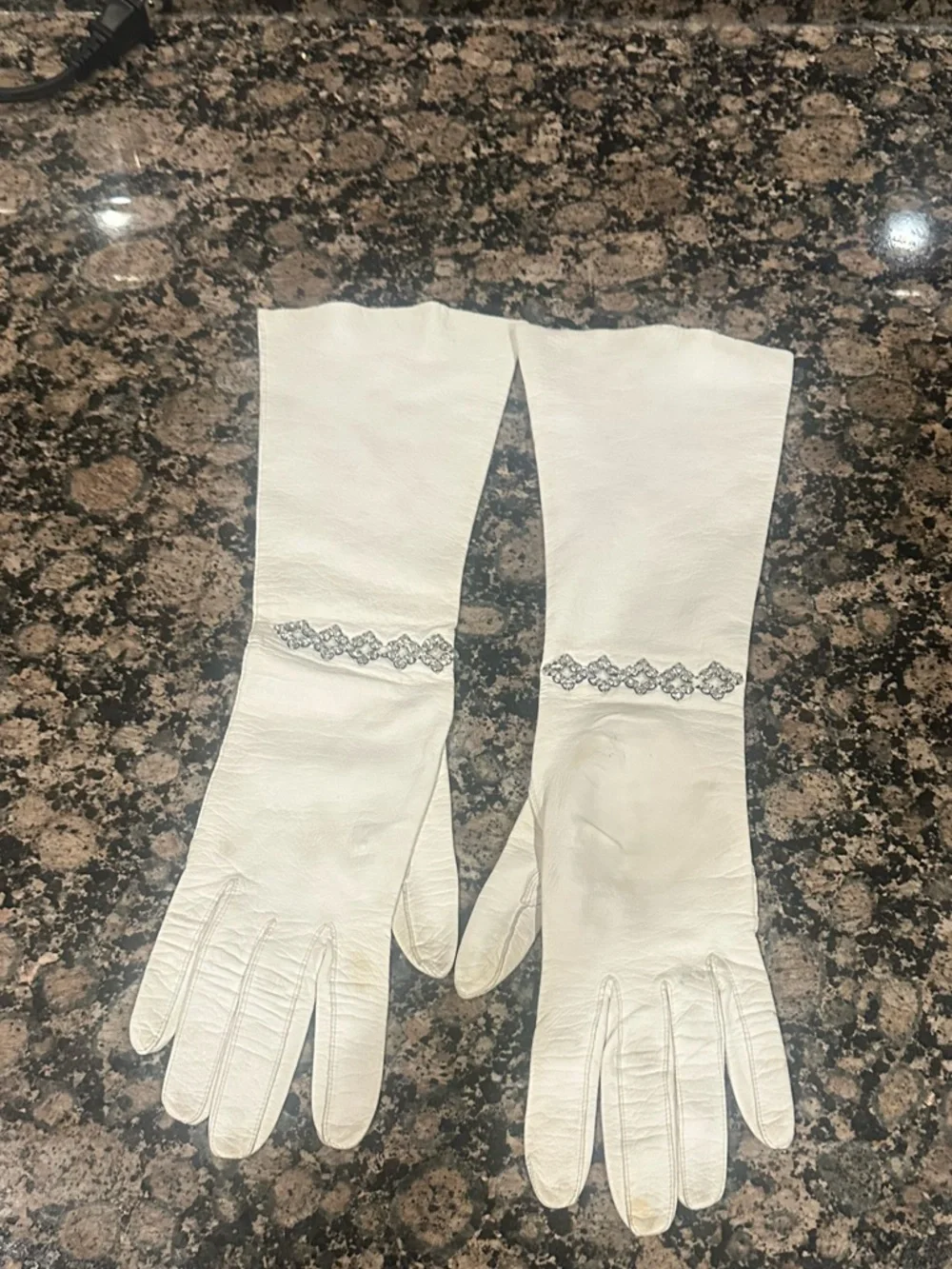 Vintage White long Gloves with‎ decorative rhinestone accents at the wrist.